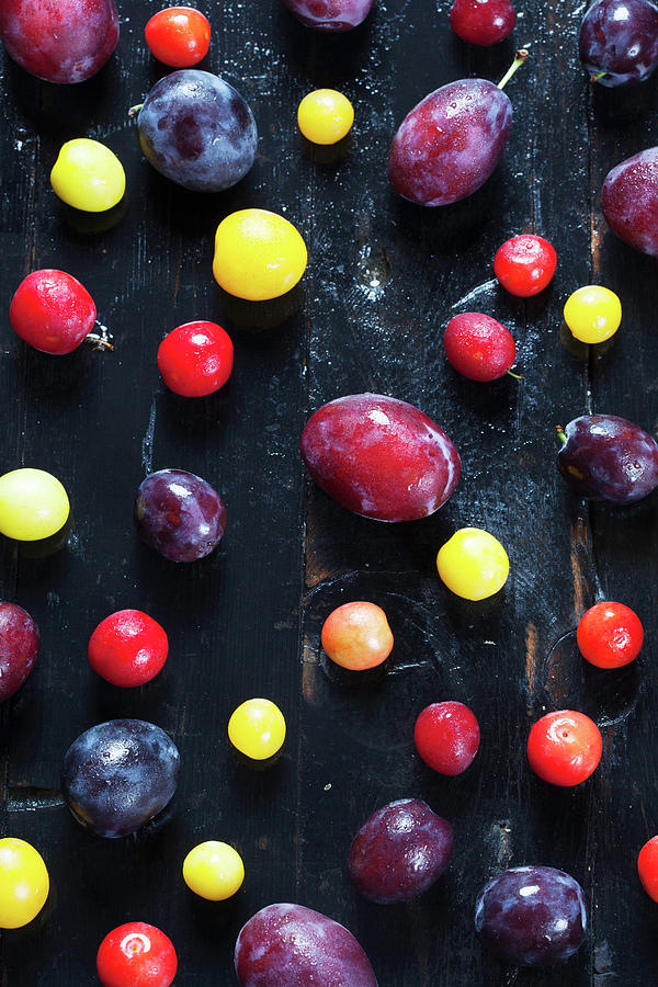 Various Stone Fruit On A Dark Wooden Surface Photograph by Kfir Harbi