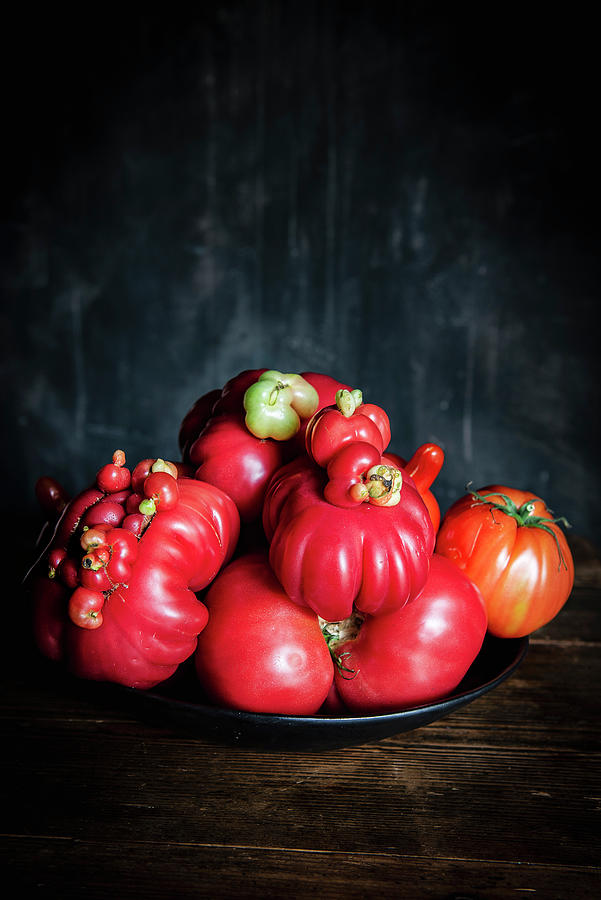Various Tomatoes On A Black Dish Photograph by Justina Ramanauskiene