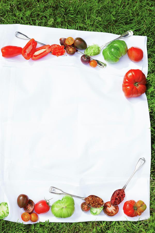 Various Tomatoes On A Cloth On The Grass Photograph by Jalag / Janne Peters