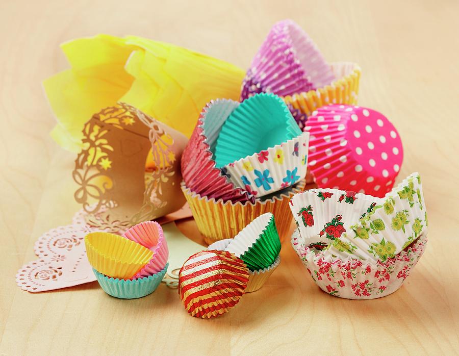 Various Types And Colours Of Cupcake And Muffin Cases On A Wooden