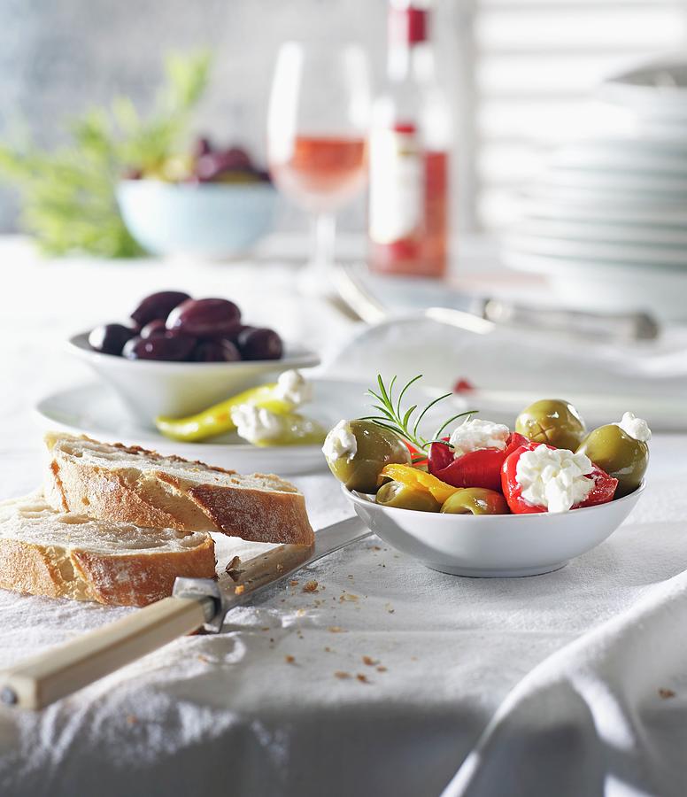 Various Types Of Antipasti With Bread And Olives On A Laid Table Photograph by Ludger Rose