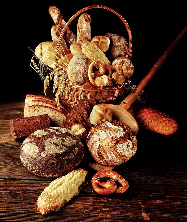 Various Types Of Bread And Rolls In A Basket With Ears Of Wheat Photograph by Bodo A. Schieren