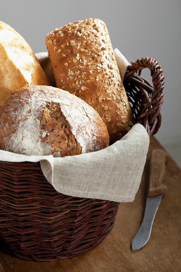 Various Types Of Bread In Bread Basket Photograph by Pawel Worytko