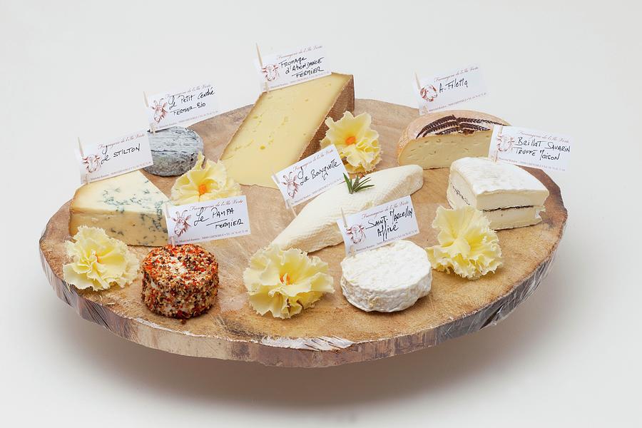 Various Types Of Cheese On A Rustic Wooden Platter Photograph by Jean-marc Blache