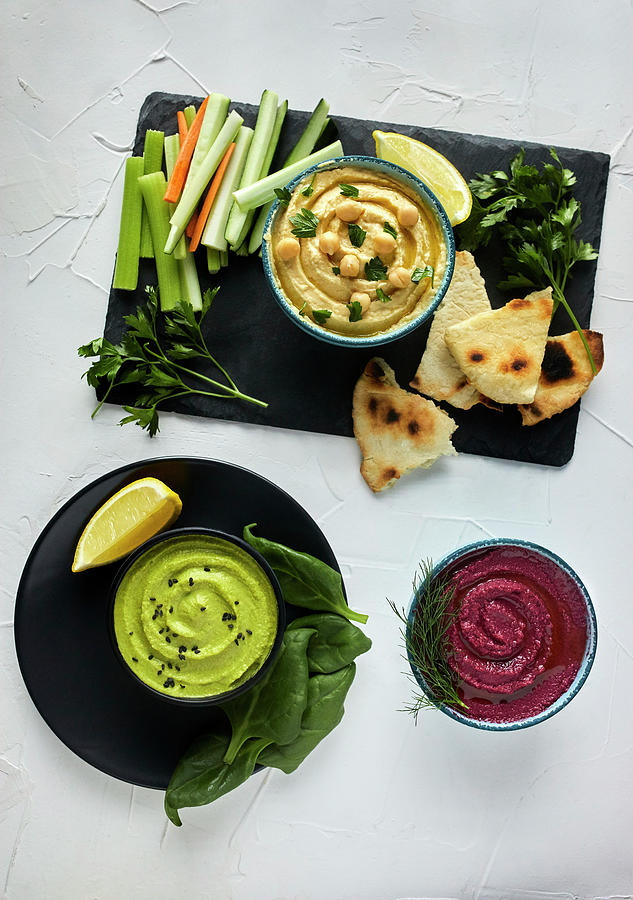 Various Types Of Hummus Served With Fresh Vegetables And Pita Bread Photograph by Natasa Dangubic