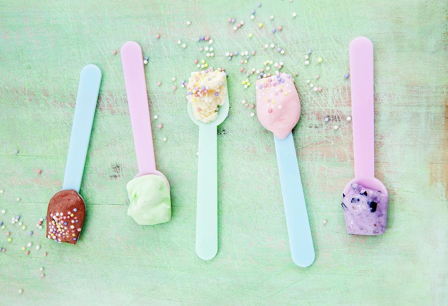Various Types Of Ice Creams On Ice Cream Spoons Scattered With Sugar Pearls: Vanilla, Strawberry, Chocolate, Blueberry And Mint Photograph by Victoria Firmston
