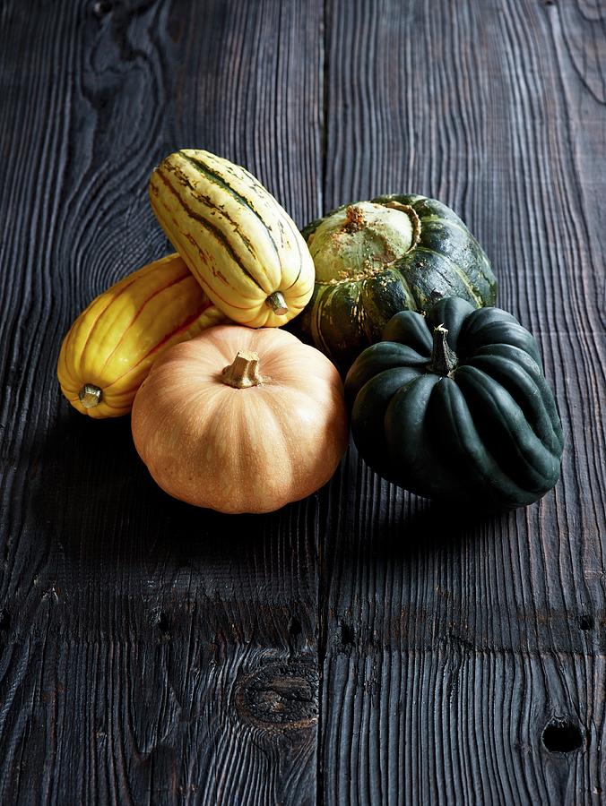 Various Types Of Squash On A Grey Wooden Surface Photograph by Leigh Beisch