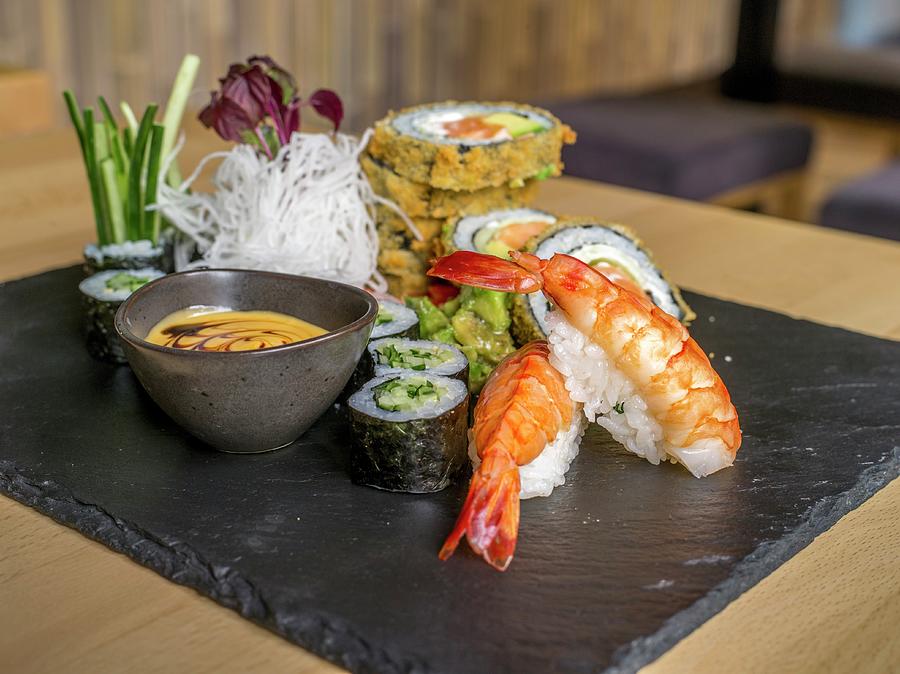 Various Types Of Sushi On A Slate Platter In A Restaurant Photograph by Manuel Krug