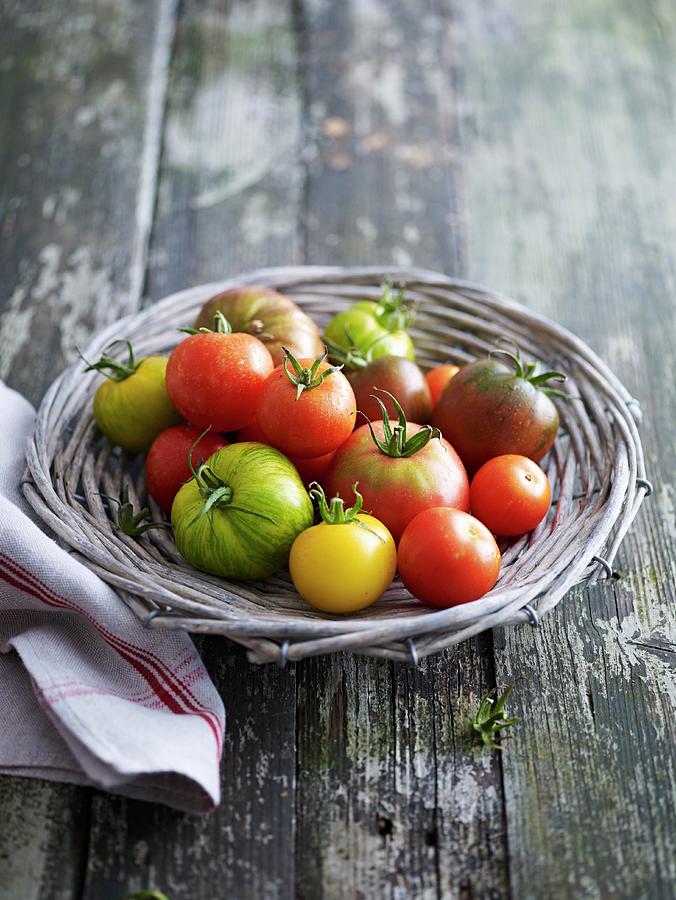 Various Types Of Tomatoes In A Wicker Basket Photograph by Brachat, Oliver