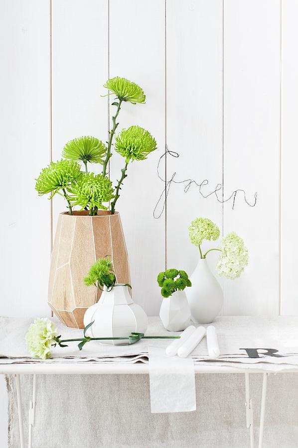 Various Vases Of Chrysanthemums, Sweet William, Carnations And Viburnum; Bent Wire Spelling green On Wall Photograph by Cornelia Weber