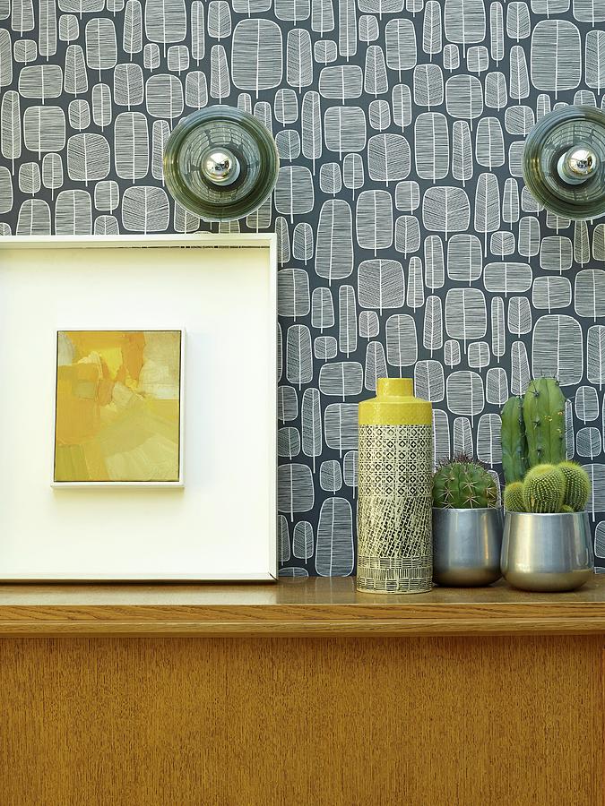 Vase Next To Cacti And Picture On Wooden Cabinet Against Wall With Retro Wallpaper Photograph by Rachael Smith