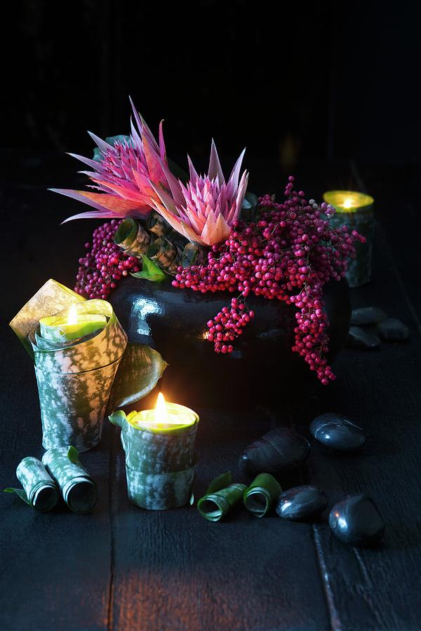 Vase Of Proteas And Beautyberries And Tealights In Plant Leaves Photograph by Alena Hrbkov