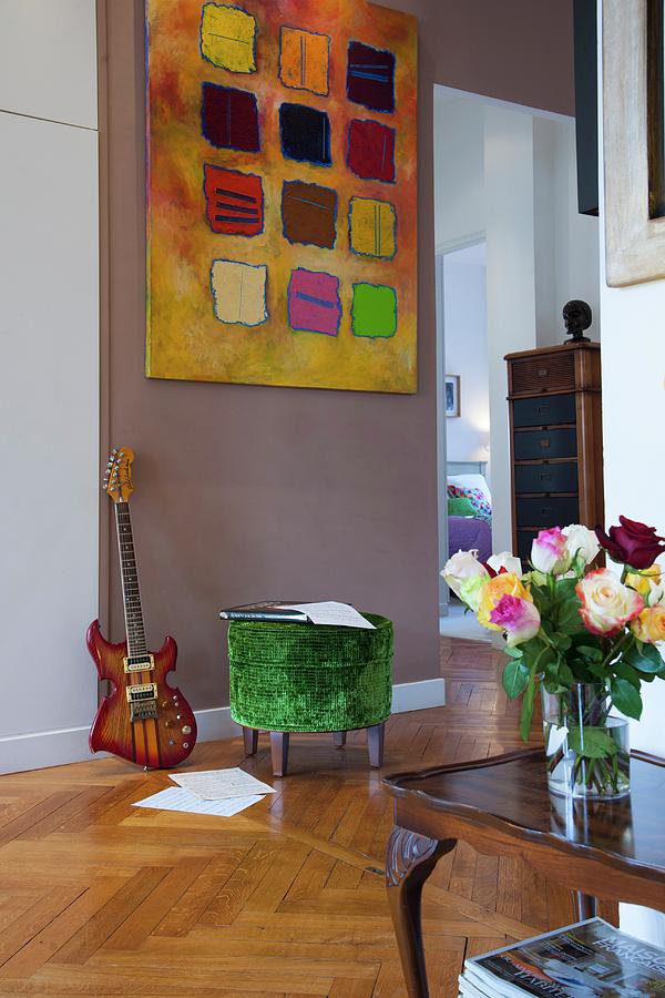 Vase Of Roses On Antique Side Table And Green Velvet Pouffe Below Modern Artwork On Painted Wall Photograph by Christophe Madamour