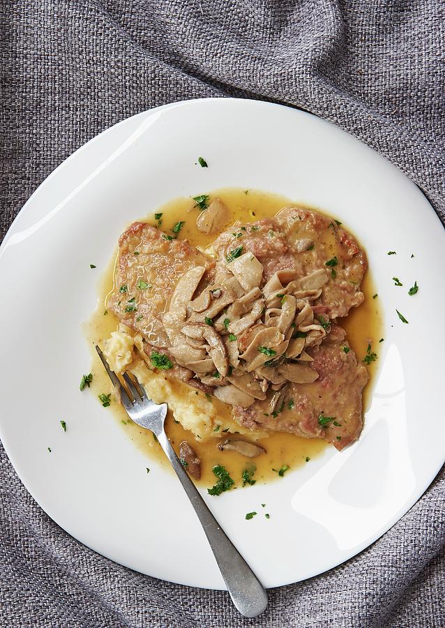 Veal Escalope With Mushroom Sauce On A Bed Of Mashed Potatoes Photograph by Robbert Koene
