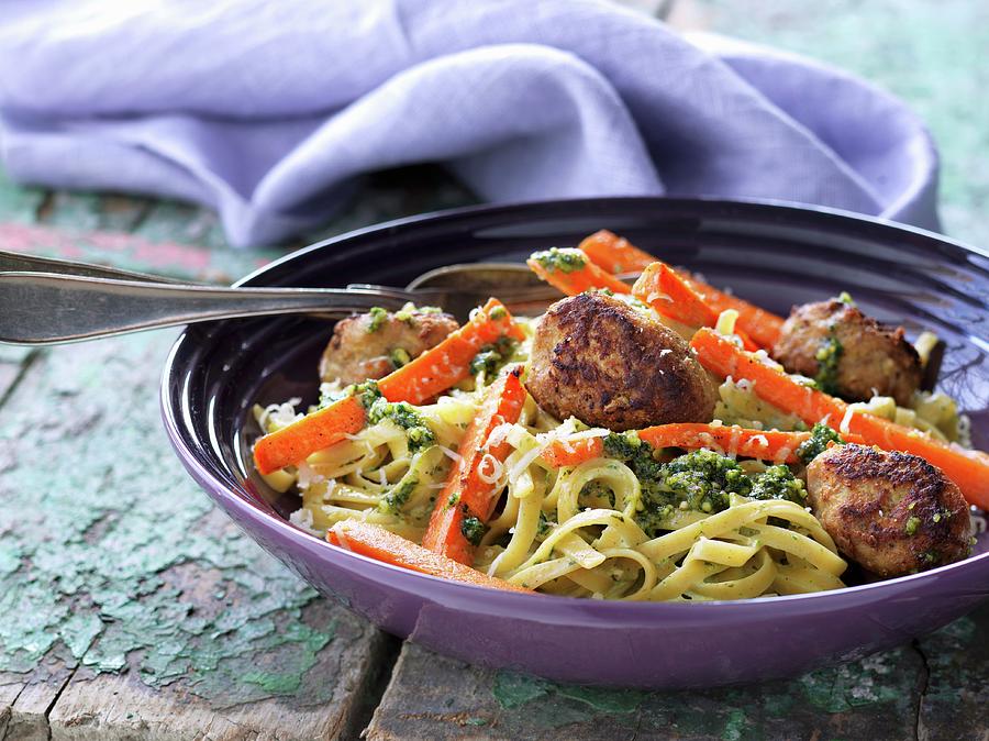Veal Meatballs In A Green Pesto Sauce With Noodles Photograph by Martin Dyrlv