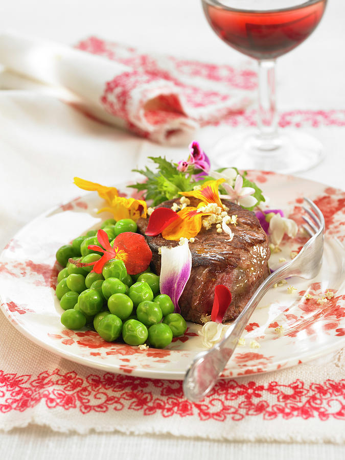 Veal Steak With Edible Flowers And Peas Photograph by Lawton