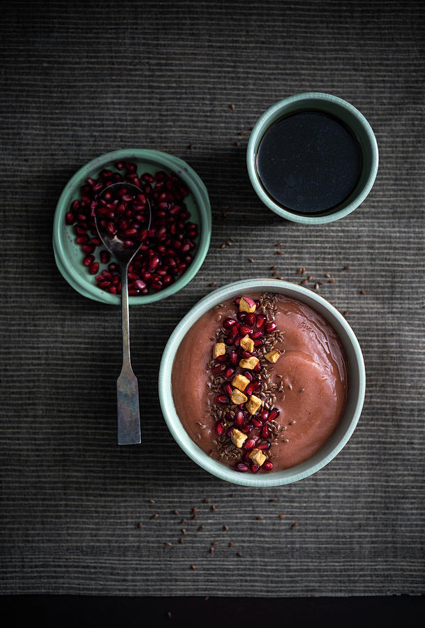 Vegan Banana And Peanut Smoothie Bowl With Pomegranate Seeds, Dried Apple And Flaxseeds Photograph by Kati Neudert