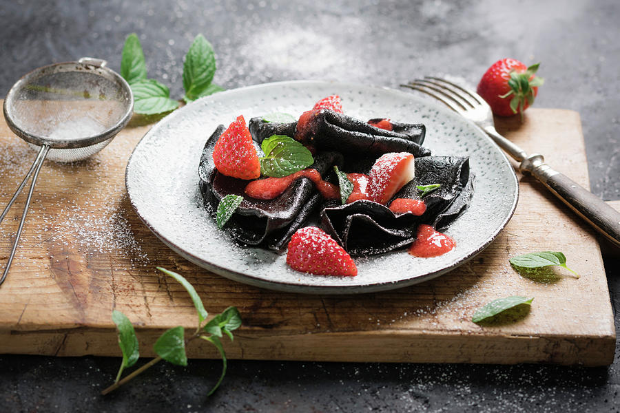 Vegan Black Crepes With Strawberry Sauce, Fresh Fruit And Mint Photograph by Kati Neudert