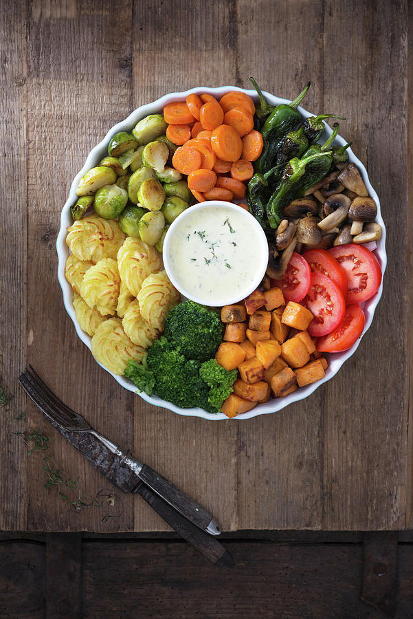 Vegan Buddha Bowl With Broccoli, Duchess Potatoes, Sweet Potatoes, Mushrooms, Brussels, Carrots, Fried Peperoni, Tomatoes And Herb Sauce Photograph by Kati Neudert