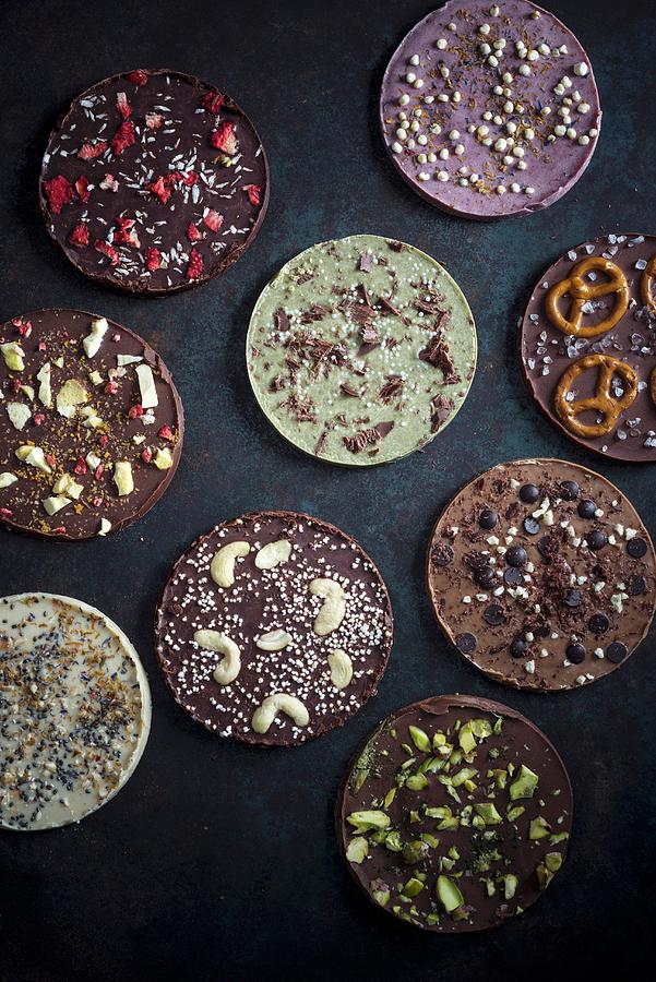 Vegan Chocolate Discs Decorated With Different Toppings Photograph by Kati Neudert