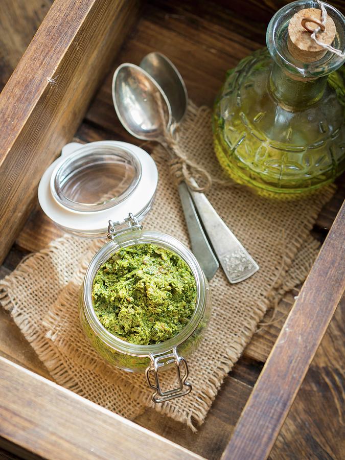 Vegan Coriander And Parsley Pesto In A Small Jar On A Wooden Surface Photograph by Magdalena Paluchowska