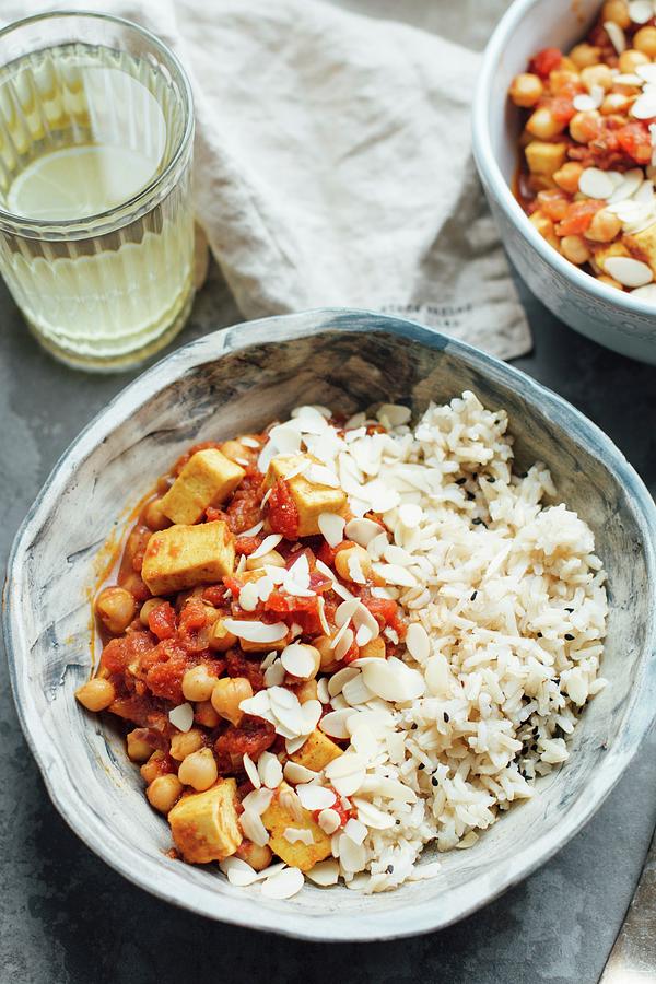 Vegan Curry With Chickpeas And Tofu, Served With Brown Rice And Almond Flakes Photograph by Kate Prihodko