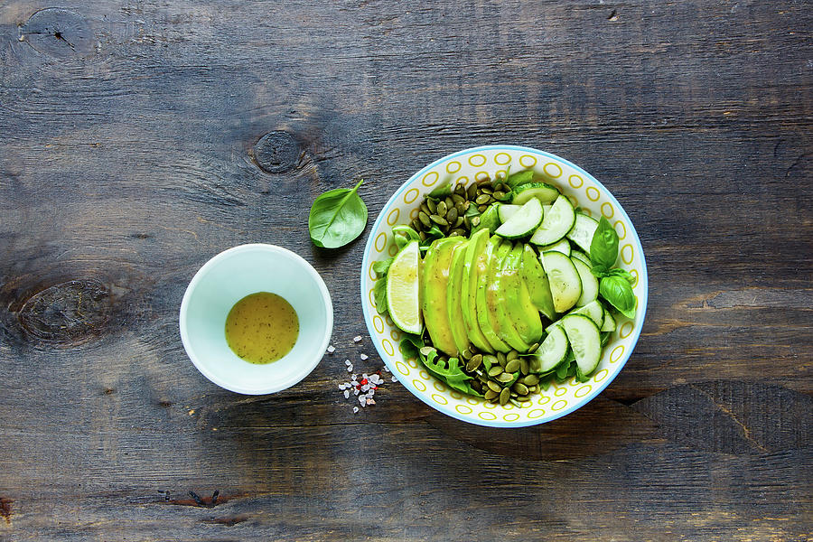 Vegan Green Summer Salad With Avocado, Arugula, Cucumbers And Pumpkin Seeds And Dressing Photograph by Yuliya Gontar