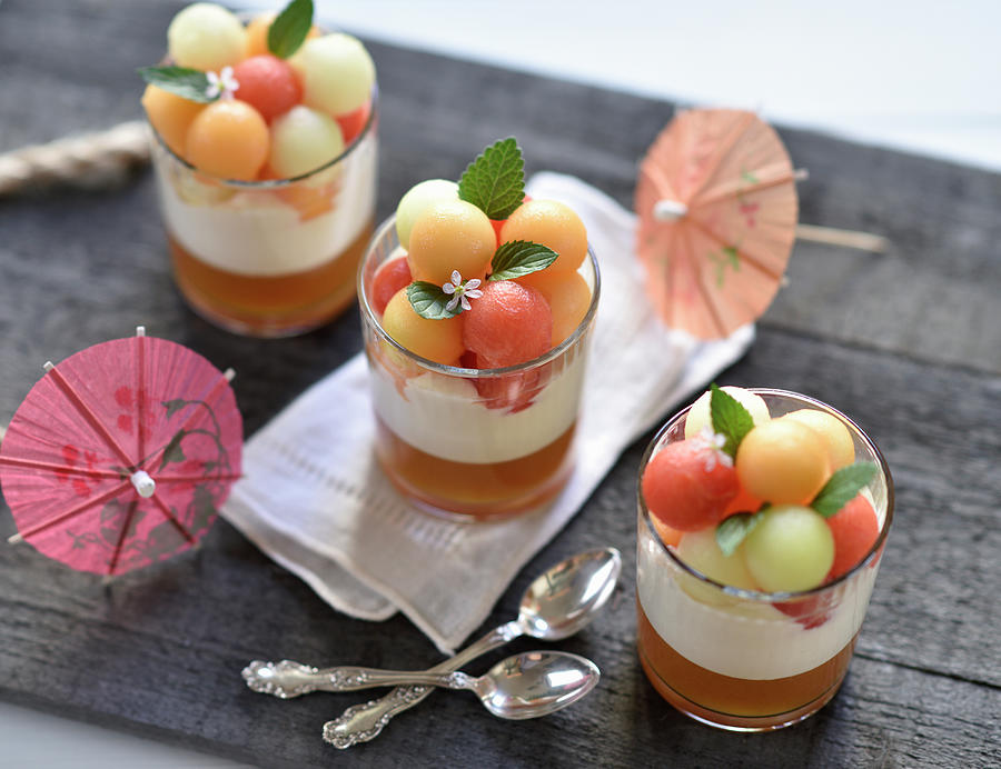 Vegan Melon Desserts In Glasses With Melon Jelly, Whipped Sour Cream And A Trio Of Different Coloured Melon Balls Photograph by B.b.s Bakery