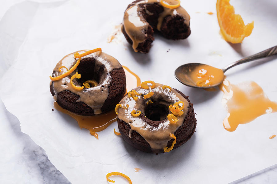 Vegan Oven-baked Chocolate Donuts With Orange Icing And Orange Zest Photograph by Kati Neudert