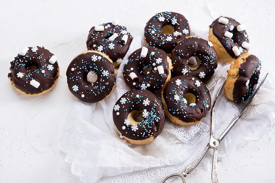 Vegan Oven-baked Donuts With Dark Icing And Wintery Sugar Decor Photograph by Kati Neudert
