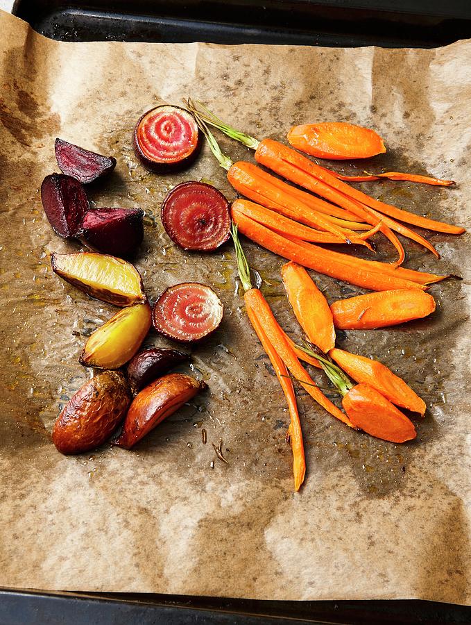 Vegan Oven Cooked Vegetables carrots, Jerusalem Artichoke, Tonda Di Chioggia On Baking Paper Photograph by Kai Schwabe
