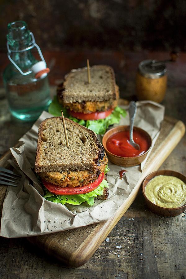 Bread Photograph - Vegan Patty Sandwiches With Tomato, Lettuce, Mustard And Ketchup by Olimpia Davies