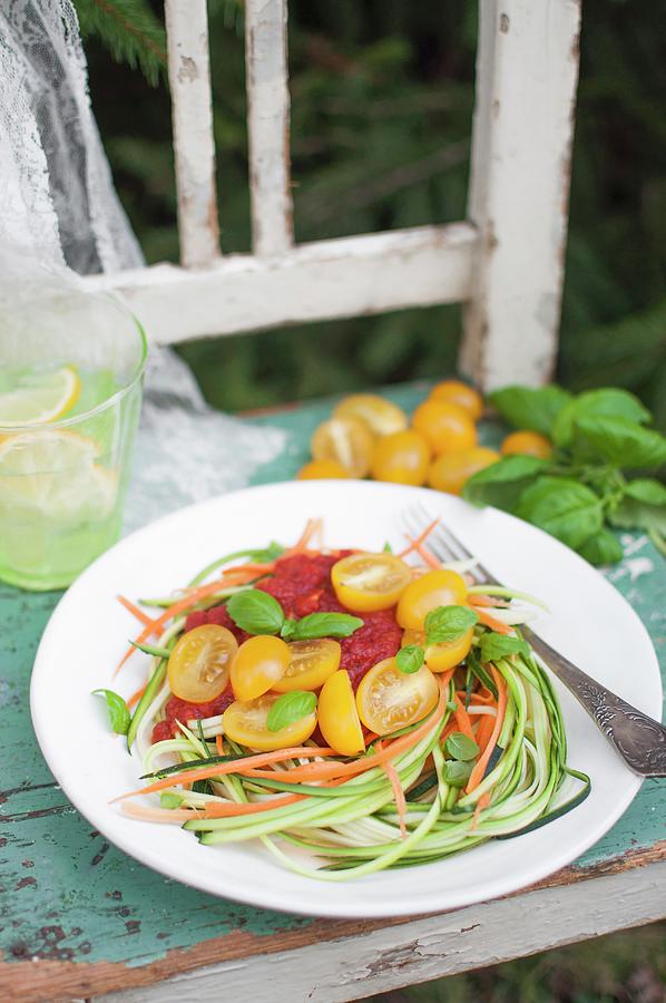 Vegan Raw Zucchini And Carrot Noodles vegetable Pasta With Tomato Sauce, Cherry Tomatoes And Fresh Basil Leaves Photograph by Kachel Katarzyna