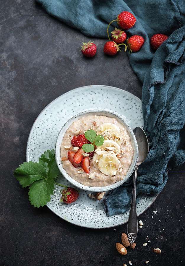 Vegan Spelt Porridge With Almond Milk, Bananas, Strawberries And Almonds Photograph by Kati Neudert