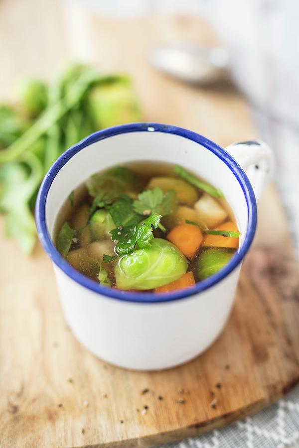 Vegetable Broth In An Enamel Cup Photograph by Jan Wischnewski