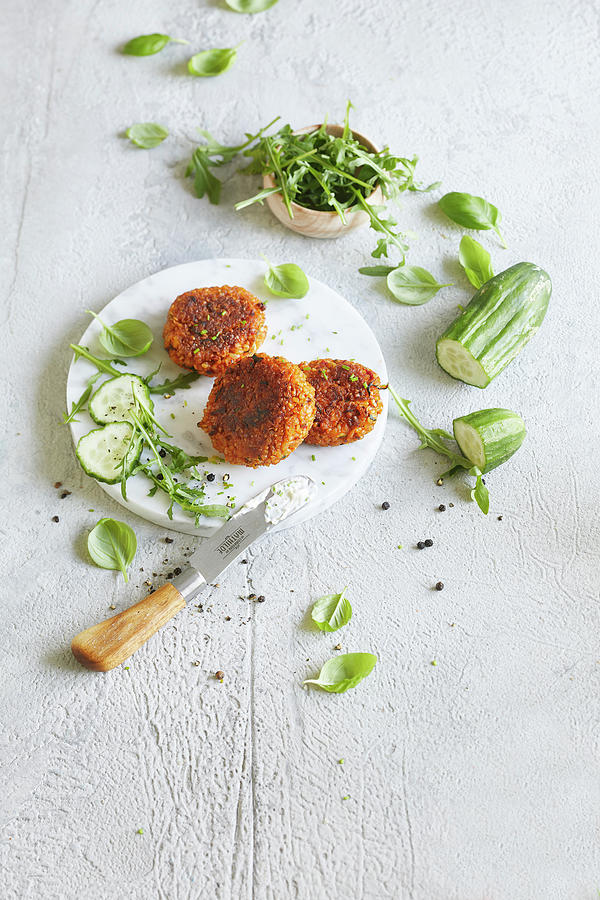 Vegetable Bulgur Wheat Patty With Cucumber, Arugula And Hemp Seeds On A Marble Board Photograph by Sabrina Sue Daniels