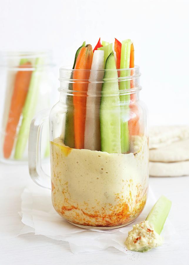 Vegetable Sticks In A Glass Jar With Houmous Photograph by Etienne Voss