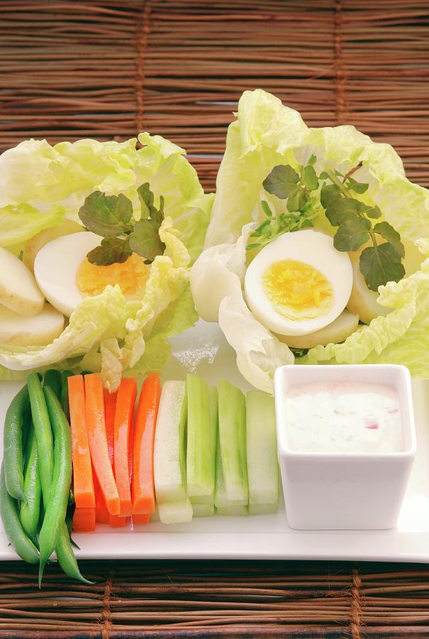 Vegetable Sticks With A Dip And Hard-boiled Eggs Served On Lettuce Leaves Photograph by John Hay