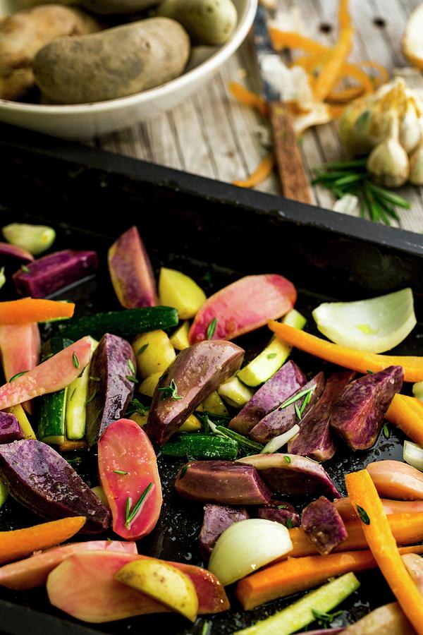 Vegetables With Olive Oil, Rosemary, Savory And Fleur De Sel On A Baking Tray Photograph by Sandra Krimshandl-tauscher