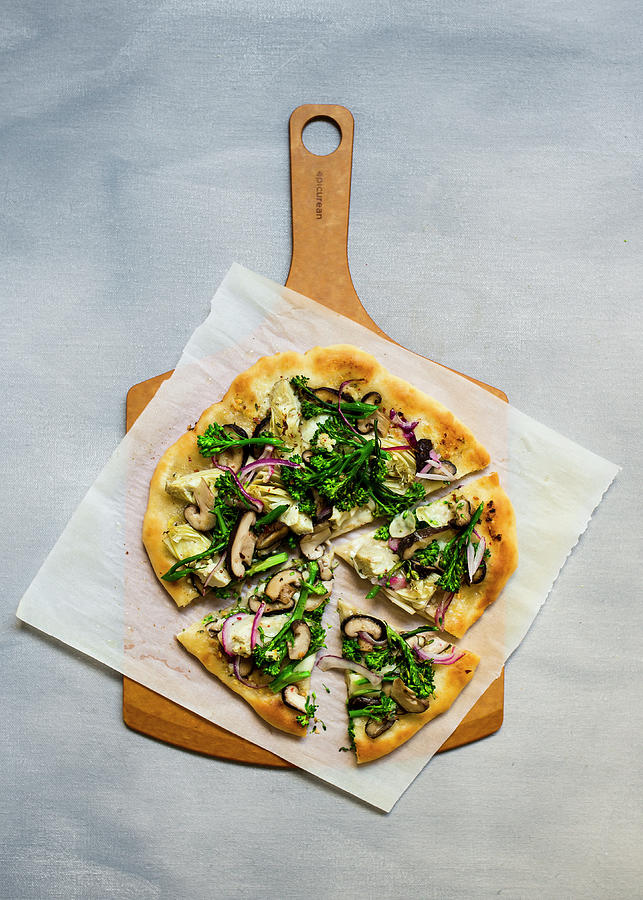 Vegetarian Pizza With Artichokes, Broccolini And Shiitake On A Wooden Board Photograph by Lisa Rees