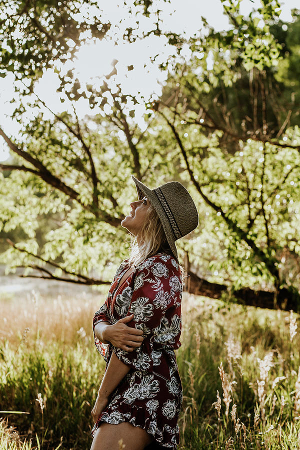 Vertical Portrait Of A Young Woman Looking Up At The Sky And Smiling Photograph by Cavan Images