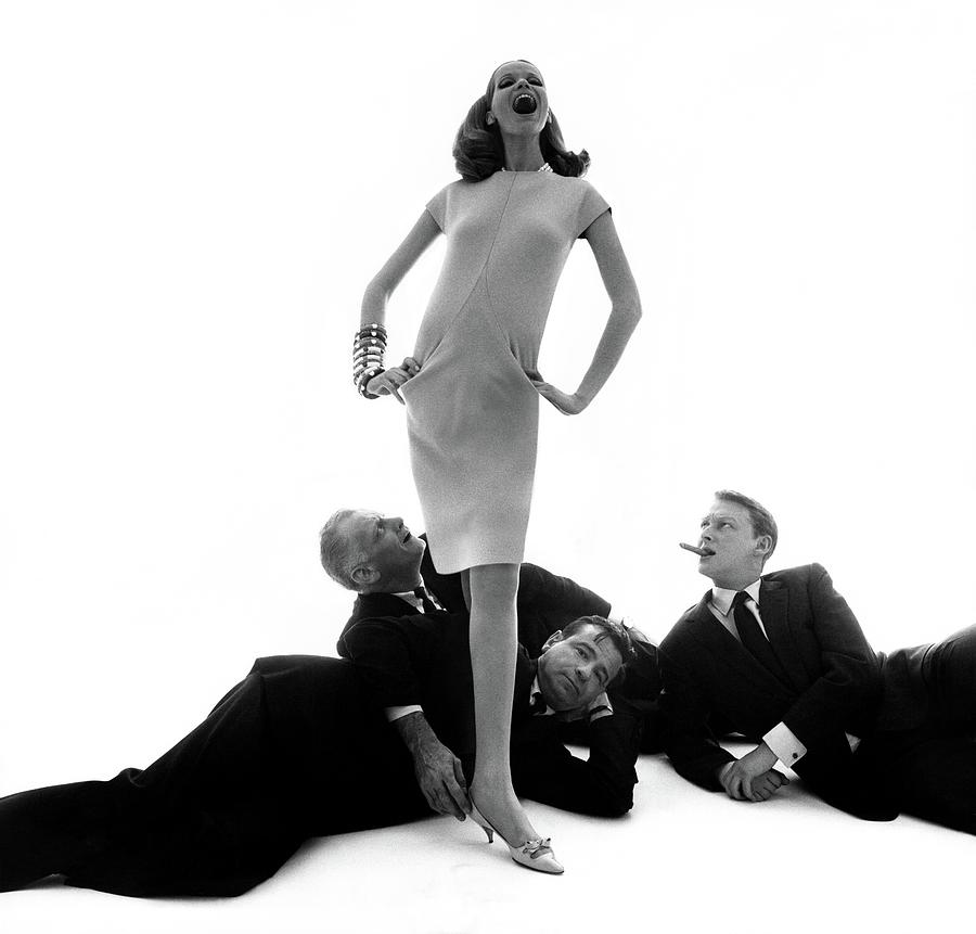 Veruschka With Three Actors At Her Feet Photograph by Bert Stern