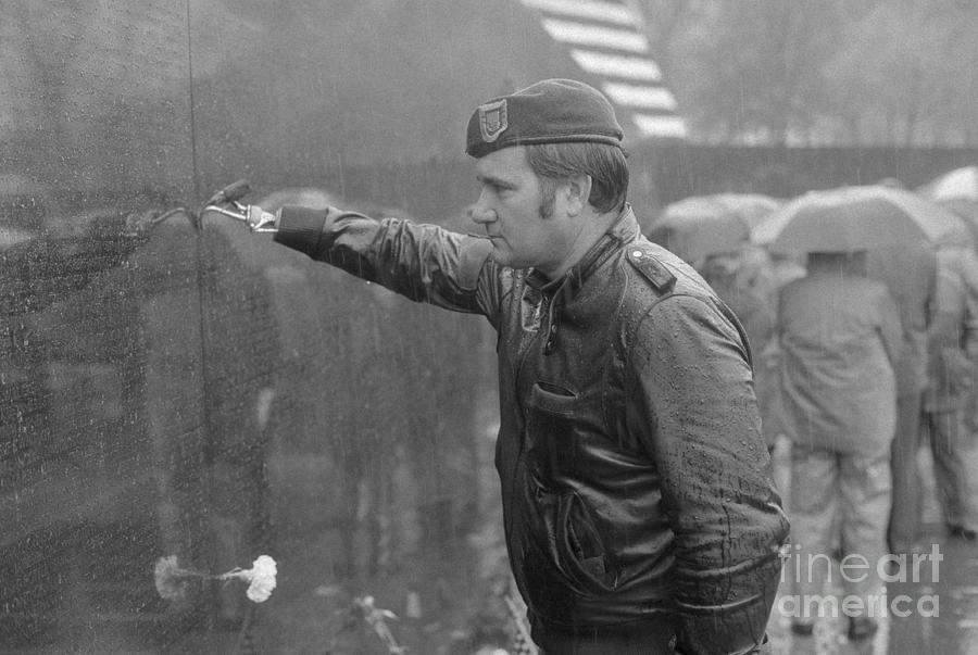 Veteran Placing Rose On Memorial Photograph by Bettmann