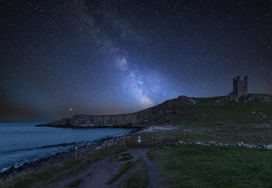 Vibrant Milky Way composite image over landscape of Dunstanburgh ...