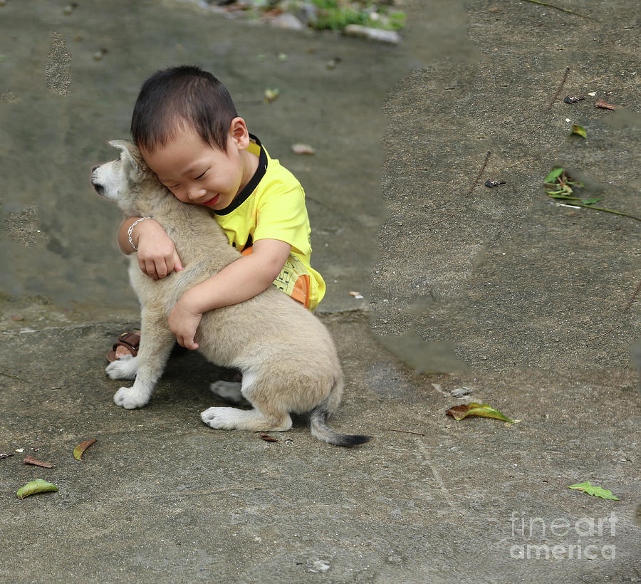 Vietnamese Boy and Puppy Hugs  Photograph by Chuck Kuhn