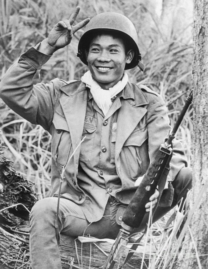 Vietnamese Soldier Smiling And Making Photograph by Bettmann