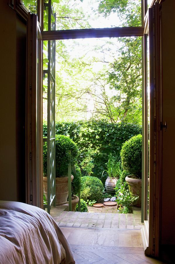 View From Bedroom Through Open Terrace Door To Sunny Terrace With Potted Box Balls Photograph by Franziska Pietsch