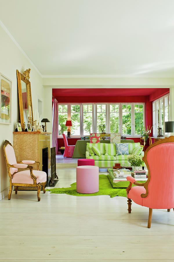 View From Seating Area With Rococo Armchairs, Pink Stools And Modern, Striped Sofa Into Dining Area In Conservatory Extension Photograph by Pics On-line / June Tuesday
