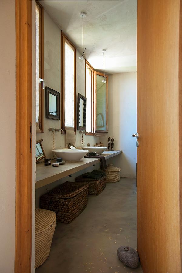 View Into Ethnic-style Bathroom With Various Baskets Under Washstand Photograph by Christophe Madamour