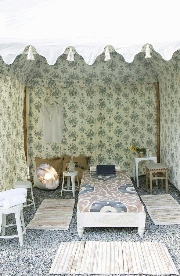 View Into Tent-like Pavilion Made From Floral Fabric With Rugs Surrounding Daybed On Gravel Floor Photograph by Annette Nordstrom